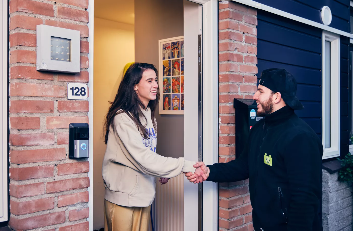 Een energie adviseur is op huisbezoek bij een vrouw voor een energie bespaarplan